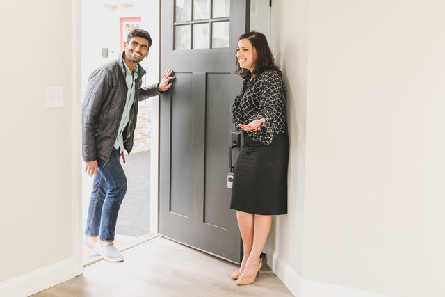 a manager opening a door for a tenant